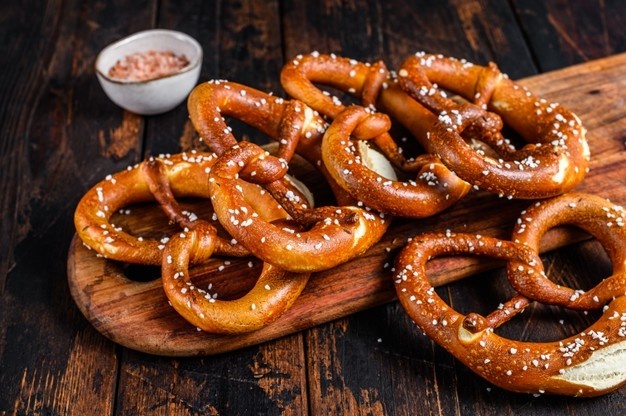homemade soft pretzels with salt on a wooden board dark wooden background top view 89816 22022