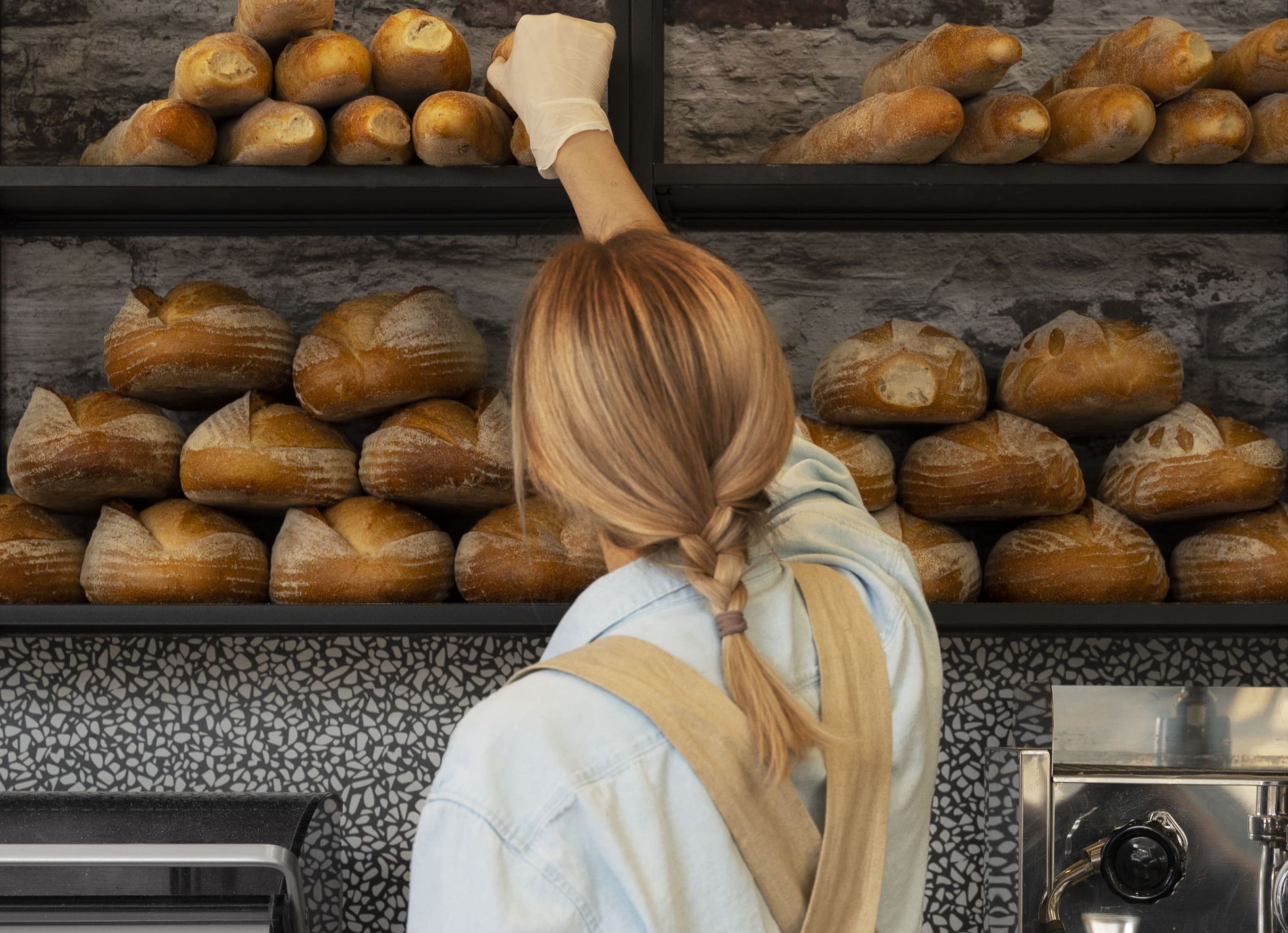 medium shot woman working bakery 2